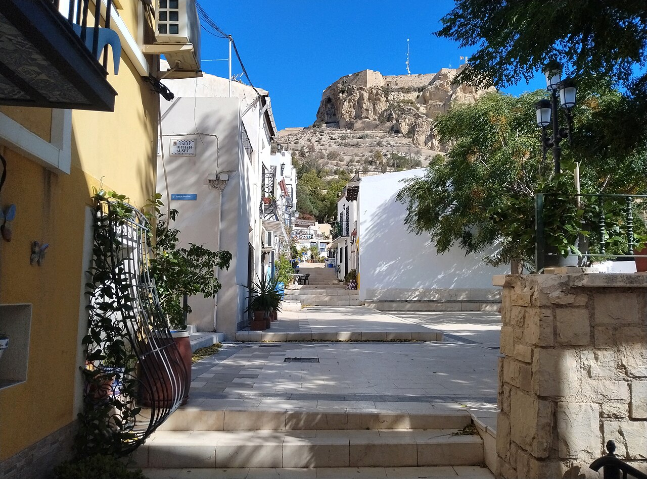 Whitewashed street in Santa Cruz with the castle hill behind