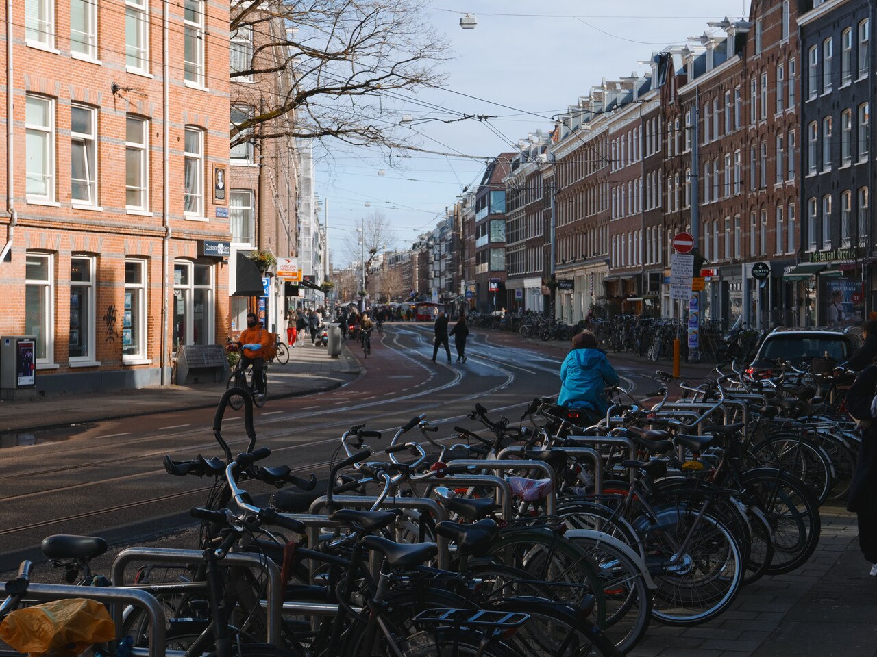 A street with bicycles and tram tracks in De Pijp