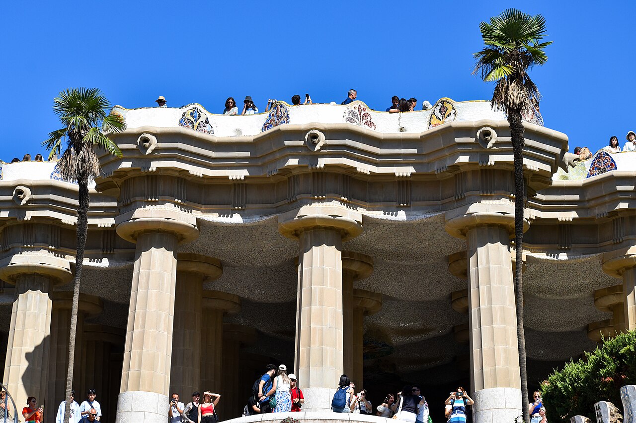 The terrace of Park Güell with mosaic benches and palms
